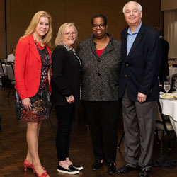 Adams poses with Tech Titans leaders Barbara Baffer (left), Deborah Sawyer and Paul Bendel.